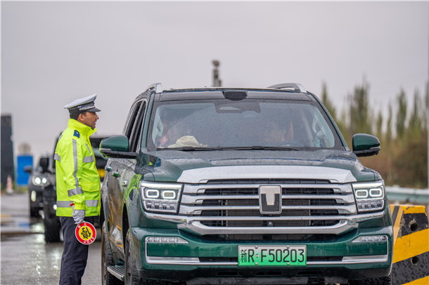 中秋假期,民警在雨天路面执勤,手持停车指示牌引导车辆有序通行。 中秋假期,民警在雨天路面执勤,手持停车指示牌引导车辆有序通行。